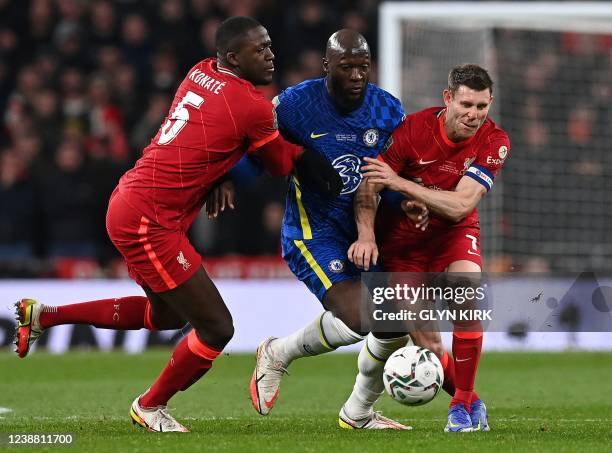 Chelsea's Belgian striker Romelu Lukaku is blocked by Liverpool's French defender Ibrahima Konate and Liverpool's English midfielder James Milner...