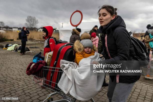 Mother and her child are seen as Ukrainian citizens arrive at the Medyka pedestrian border crossing fleeing the conflict in their country, in eastern...