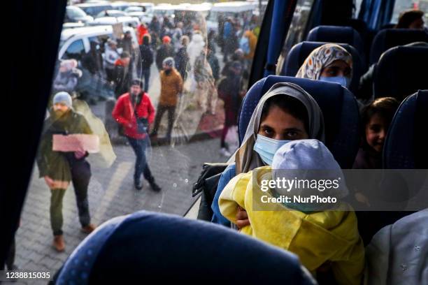 People from the Middle East who fled from Ukraine arrive on a bus to a supermarket parking lot after crossing Ukrainian-Polish border in Medyka....