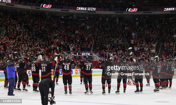 The Carolina Hurricanes perform a Storm Surge celebration following a 2-1 NHL victory over the Edmonton Oilers on February 27, 2022 at PNC Arena in...