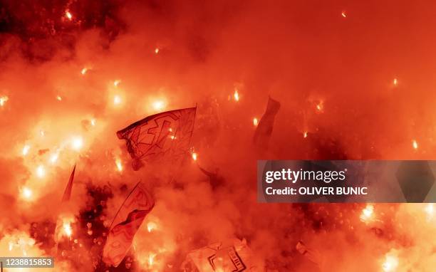 Red Star supporters light red flares during the Serbian National soccer league derby match between Red Star and Partizan at The Rajko Mitic Stadium...