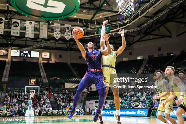 Michael Forrest of the Florida Atlantic Owls attempts a shot over Clyde Trapp of the Charlotte 49ers during a basketball game between the Charlotte...