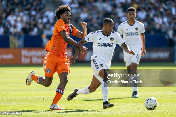 Douglas Costa of Los Angeles Galaxy battles Talles Magno of New York City during the match at the Dignity Health Sports Park on February 27, 2022 in...