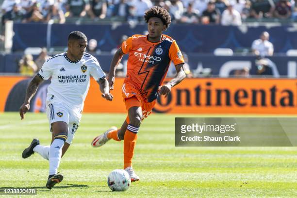 Douglas Costa of Los Angeles Galaxy battles Talles Magno of New York City during the match at the Dignity Health Sports Park on February 27, 2022 in...