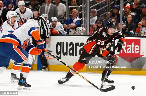 Jakob Silfverberg of the Anaheim Ducks battles for the puck against Ross Johnston of the New York Islanders during the game at Honda Center on...