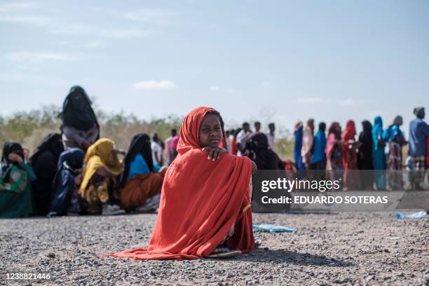 Girl seats as she waits in line to be registered by the authorities at the compound of the Agda Hotel, in the city of Semera, Afar region, Ethiopia,...