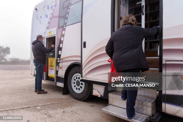 Man withdraws money at a cashpoint set up in a library bus in the village of Anover de Tormes, in the northern Spanish province of Salamanca on...