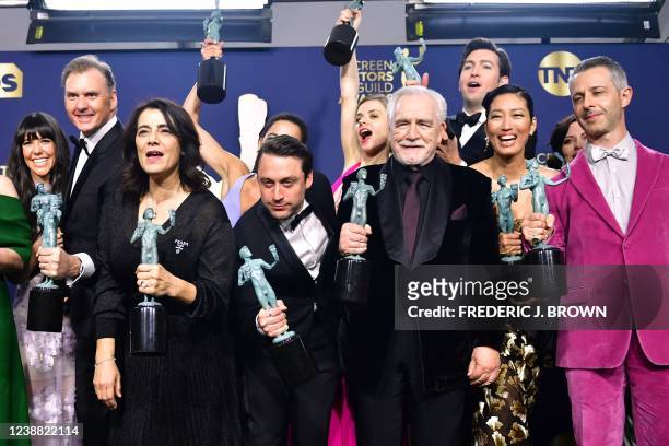 Scottish actor Brian Cox , US actor Jeremy Strong and members of the cast from Succession pose with the award for Outstanding Performance by an...