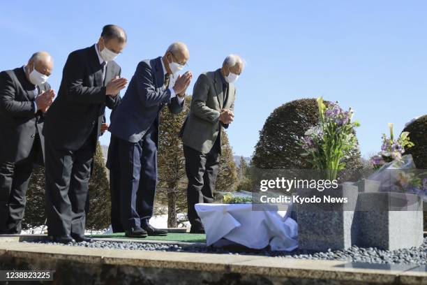 Former police troopers visit a memorial to two police officers, who were killed in 1972 in a shoot-out with radicals, in the Nagano Prefecture town...