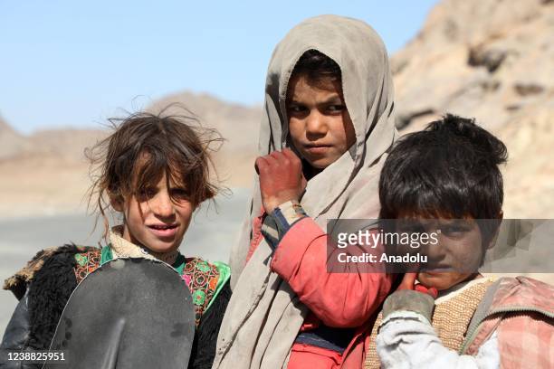 Children working for road repairment are seen in Kabul, Afghanistan on February 5, 2022. Roads, destroyed by explosions due to decades of conflict in...