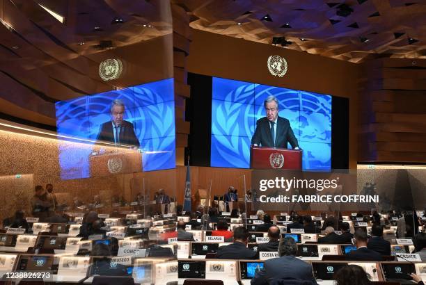 Secretary-General Antonio Guterres appears on a screen as he delivers a remote speech at the opening of a session of the UN Human Rights Council on...