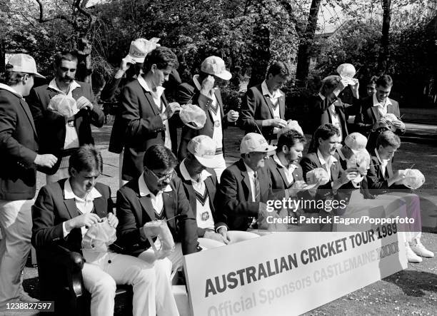 The Australia cricket team get ready for photos wearing promotional baseball caps with built-in radios during a photoshoot for tour sponsor...