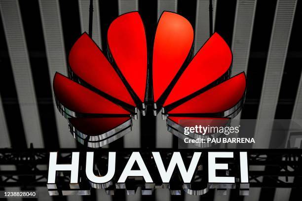 This photograph shows the logo of Huawei on the opening day of the MWC in Barcelona on February 28, 2022. - The world's biggest mobile fair is held...