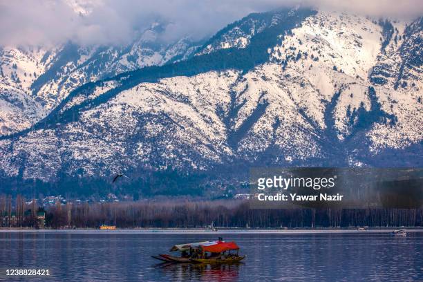 Tourists take Shikara boat rides on the waters of Dal lake, on February 28, 2022 in Srinagar, the summer capital of Indian administered Kashmir,...