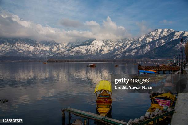 Shikara boats are moored to the bank of Dal lake, on February 28, 2022 in Srinagar, the summer capital of Indian administered Kashmir, India. Kashmir...