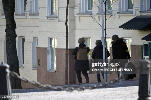 Young fighters of the Ukrainian Territorial Defence Forces, the military reserve of the Ukrainian Armed Forces, with Kalashnikov guns walk in the...