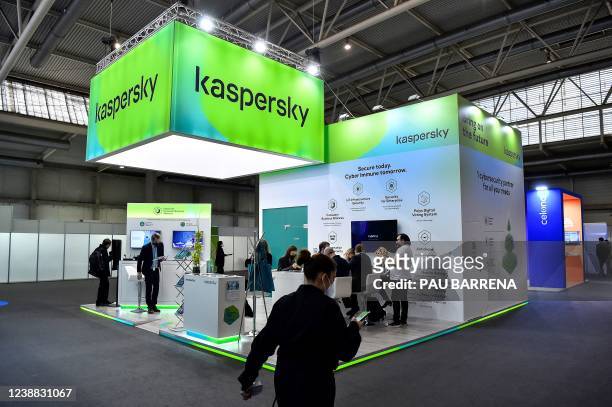 Visitors sit at the stand of Russian antivirus software development company Kaspersky Lab on the opening day of the MWC in Barcelona on February 28,...