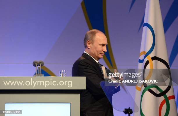Russian President Vladimir Putin leaves the stage after his speech at the International Olympic Committee Gala Dinner on February 6, 2014 in Sochi,...