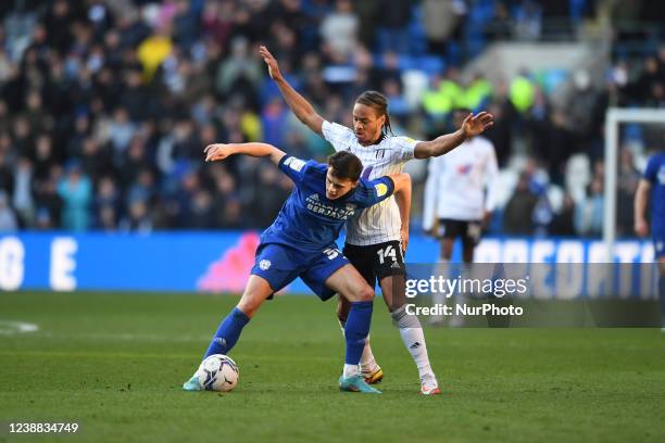 Perry Ng of Cardiff City battles to hold onto possession from Bobby Decordova-Reid of Fulham during the Sky Bet Championship match between Cardiff...