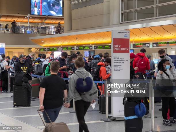 Passengers stand in line at the Air France ticket counter at Los Angeles International Airport in Los Angeles, California, on February 28, 2022.