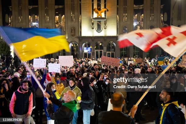 Protestors wave Ukrainian and Georgian flags, and hold placards during a rally in support of Ukraine after Russia began it's military invasion to the...