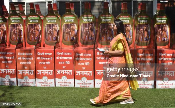 Women walk pass in front of Janmant boxes during the Delhi BJP State President Adesh Gupta, MPs Pravesh Sahib Singh and Hansraj Hans along with other...