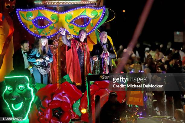 Musician and actor Harry Connick, Jr., one of the founding members of the Krewe of Orpheus, throws beads to the crowd as the 1,300 riders of Orpheus...