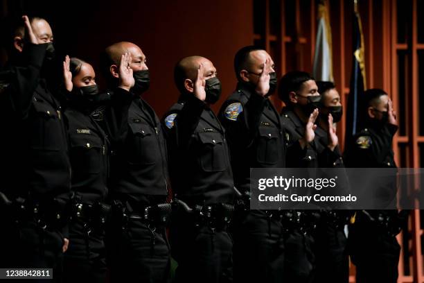 Thirteen members of the 274th Recruit Class take an oath at the San Francisco Police Department graduation ceremonty, attended by London Breed, mayor...