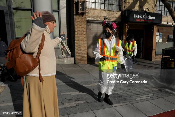 Women waiting for the bus is asked to move while San Francisco Public Works pressure washes the sidewalk along Van Ness Ave. In the Tenderloin...