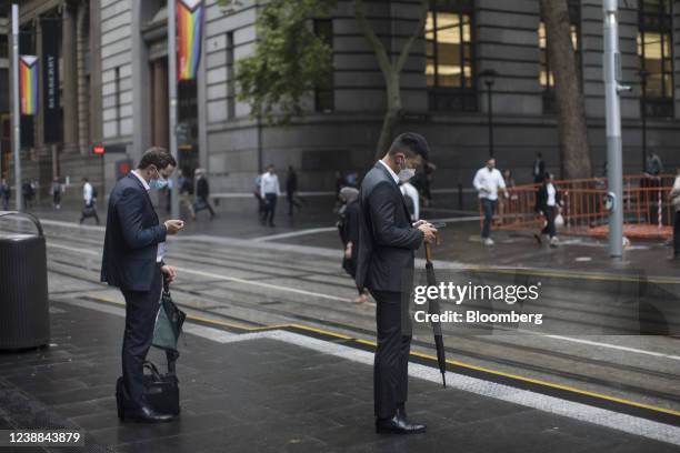 Commuters wait at a light rail train station in Sydney, Australia, on Monday, Feb. 28, 2022. Australia is scheduled to release gross domestic product...