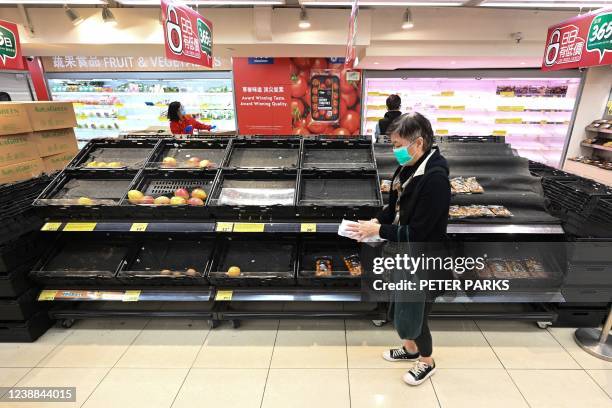 Empty shelves in a supermarket are seen in Hong Kong on March 1 as panic buying returned to the city this week with many supermarket shelves stripped...