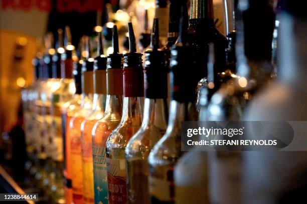 Various bottles of alcohol are lined up at Caddies bar and grill in Bethesda, Maryland, on February 28, 2022. Regulars at Caddies bar and grill in...