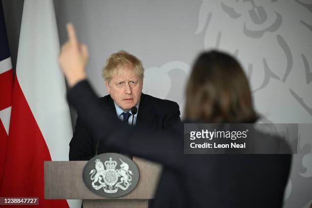 British Prime Minister Boris Johnson takes a question from Ukrainian journalist Daria Kaleniuk about the no fly zone as he gives a press conference...