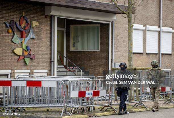 Soldier and police officer secure the court bunker in Amsterdam-Osdorp prior to the continuation of the Marengo criminal case, in Amsterdam, on March...
