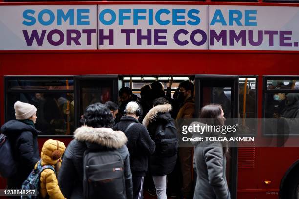 People queue to board a London bus on March 1 during a day of strike action on Transport for London's London Underground tube service. - London's...