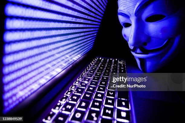 Binary code displayed on a laptop screen and Guy Fawkes mask are seen in this illustration photo taken in Krakow, Poland on March 1, 2022. Global...