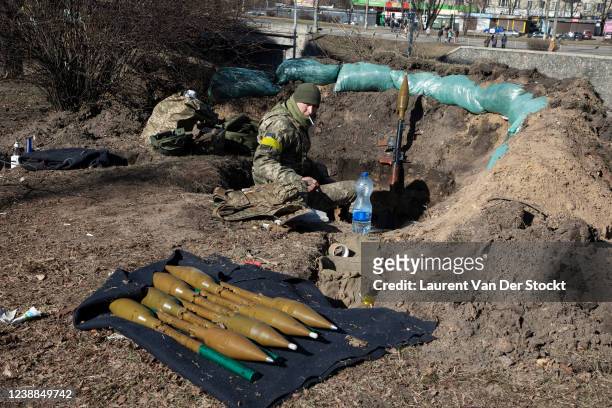 Ukrainian soldiers take up a position on a road after digging trenches and piling up sandbags on February 28,2022 in Kyiv, Ukraine. As Russia’s...