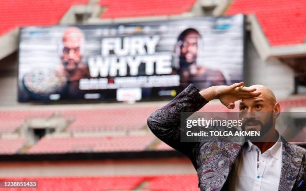 World Boxing Council heavyweight title holder Britain's Tyson Fury poses on the pitch after a press conference at Wembley Stadium in west London on...