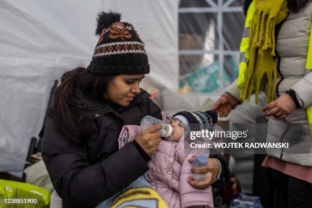 Woman from Pakistan feeds her two-month-old baby in a tent at the border crossing in Medyka, eastern Poland as refugees continue to arrive from...