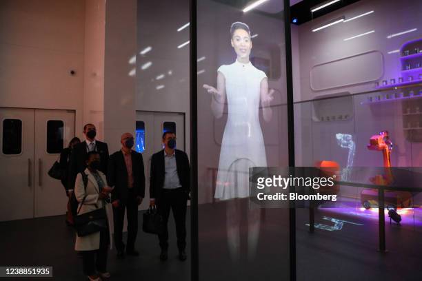 Attendees view a hologram at the Ericsson AB stand on day two of the MWC Barcelona at the Fira de Barcelona venue in Barcelona, Spain, on Tuesday,...