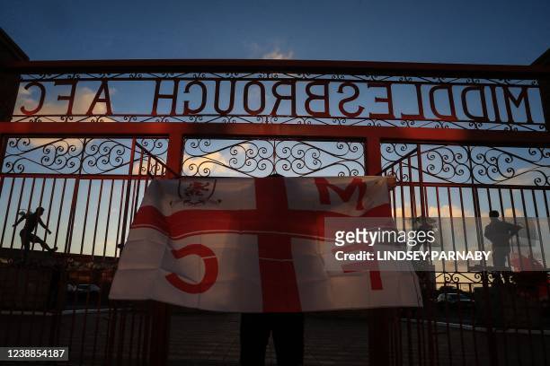 Middlesbrough's supporter waves with his club flag as he arrives at the Riverside Stadium to attend the English FA cup fifth round football match...
