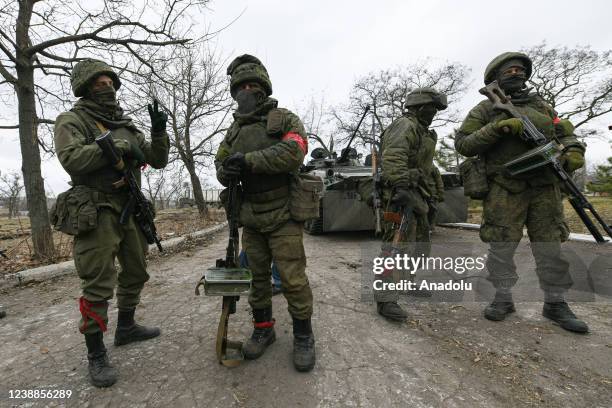 Pro-Russian separatists, in uniforms without insignia, gather in the separatist-controlled settlement of Mykolaivka and Bugas, in Donetsk region of...