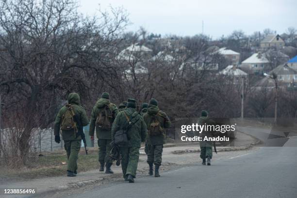 Pro-Russian separatists, in uniforms without insignia, gather in the separatist-controlled settlement of Mykolaivka and Bugas, in Donetsk region of...