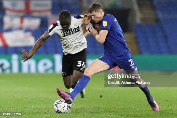 Festy Ebosele of Derby County challenged by Mark McGuinness of Cardiff City during the Sky Bet Championship match between Cardiff City and Derby...