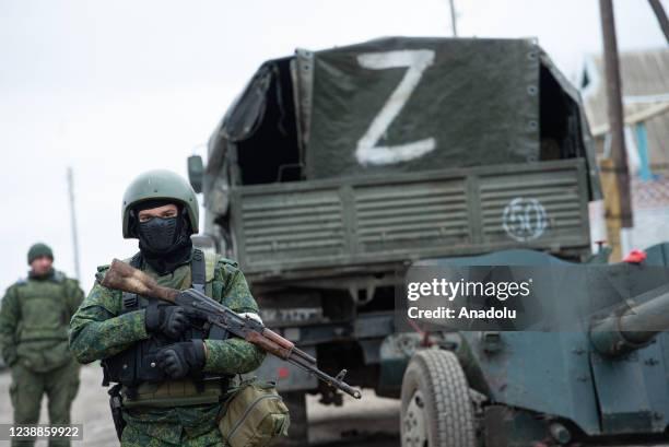 Pro-Russian separatists, in uniforms without insignia, gather in the separatist-controlled settlement of Mykolaivka and Bugas, in Donetsk region of...