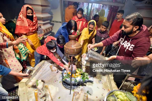 Devotees offer prayers on the occasion of Mahashivratri festival, at a Dakshinpuri temple on March 1, 2022 in New Delhi, India.