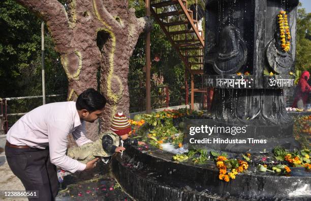 Hindu Devotees offer milk and water over a Shivling inside a temple during the Maha Shivratri festival at Shiv temple Preet Vihar on March 1, 2022 in...