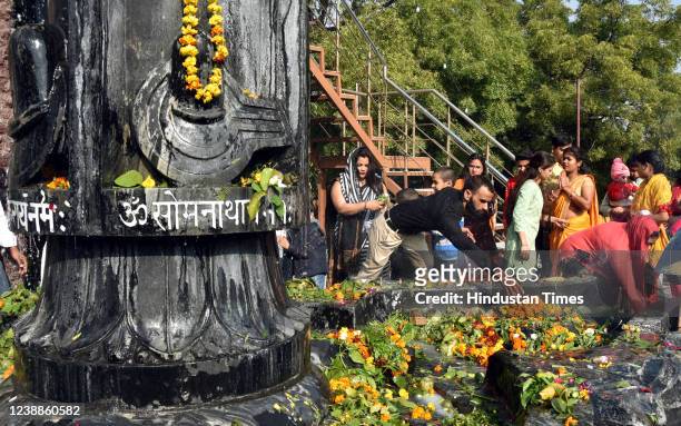 Hindu Devotees offer milk and water over a Shivling inside a temple during the Maha Shivratri festival at Shiv temple Preet Vihar on March 1, 2022 in...