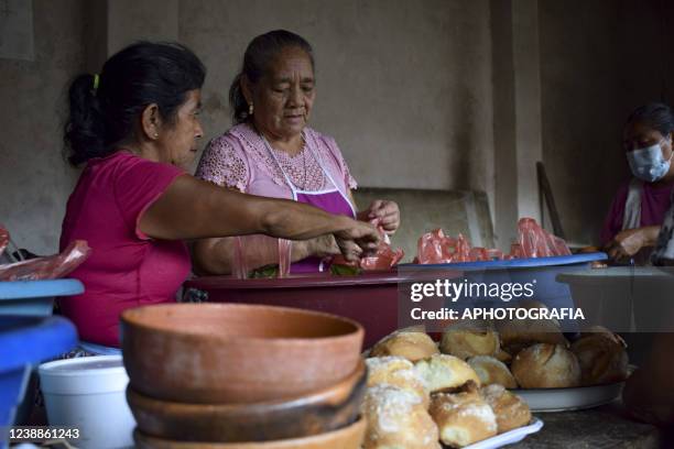 Revelers prepare tamales during the celebration of 'Fiesta de las Comadres', also known as 'Martes de Carnaval' in municipality Izalco, on March 1,...