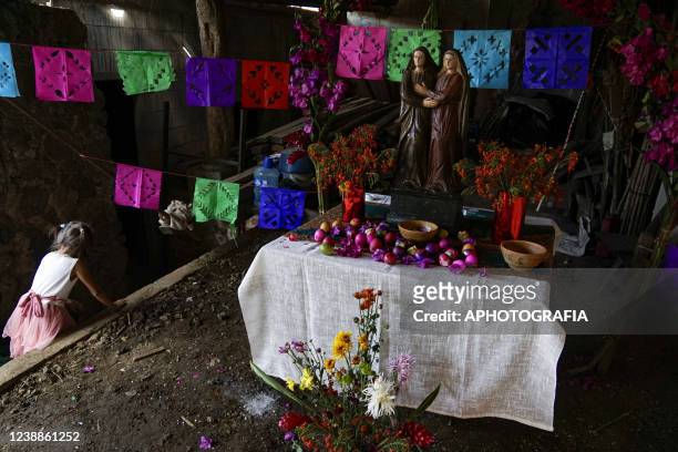 Reveler looks at an altar during the celebration of 'Fiesta de las Comadres', also known as 'Martes de Carnaval' in municipality Izalco, on March 1,...